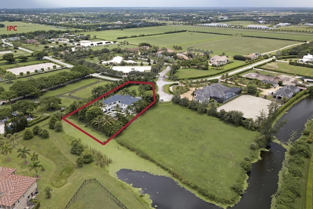 birds eye view of property featuring a rural view and a water view