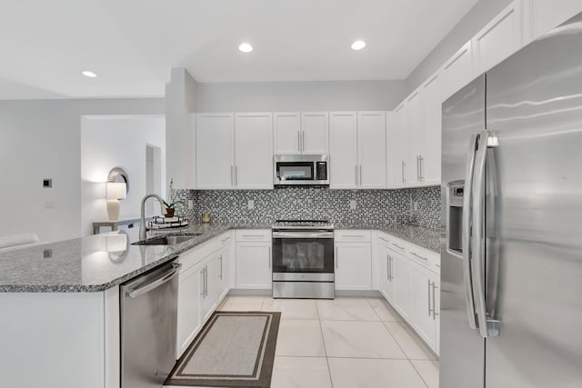 kitchen with sink, stainless steel appliances, and white cabinets