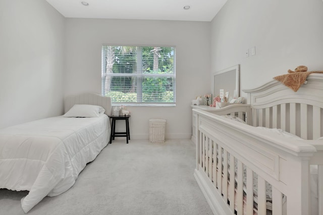 bedroom featuring light colored carpet