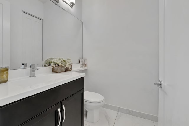 bathroom with toilet, tile patterned floors, and vanity