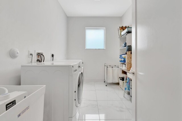 laundry area with light tile patterned flooring and independent washer and dryer