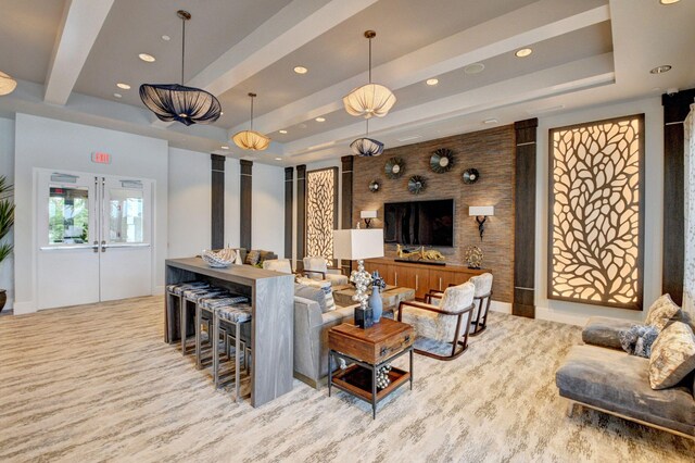 living room with a raised ceiling and french doors