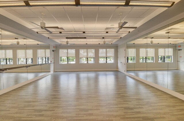 exercise room featuring ceiling fan and hardwood / wood-style flooring