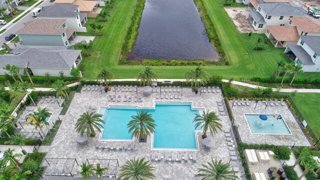 view of pool with a patio area and a yard