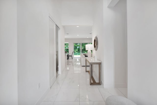 hall featuring light tile patterned flooring