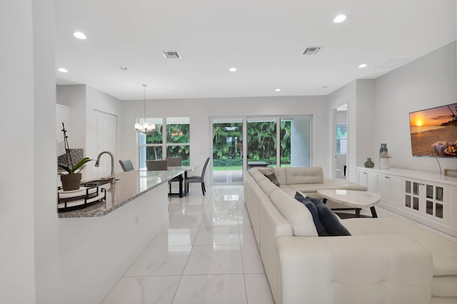 tiled living room with a chandelier