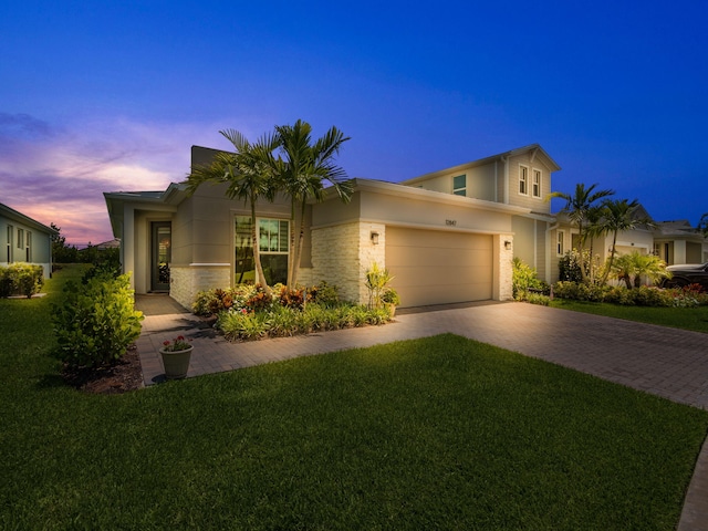 view of front of house featuring a yard and a garage