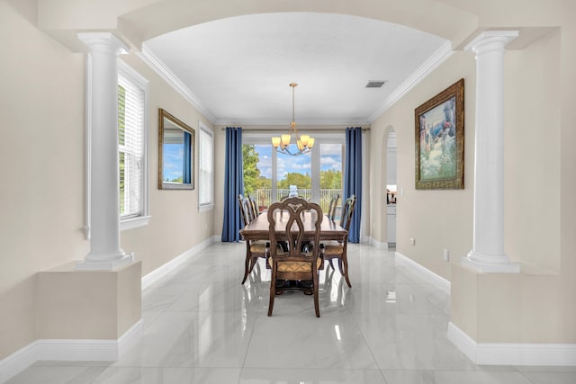 dining space with light tile patterned floors, an inviting chandelier, ornamental molding, and ornate columns