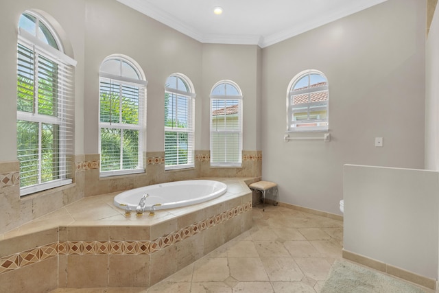 bathroom featuring crown molding, a relaxing tiled tub, tile patterned flooring, and a healthy amount of sunlight