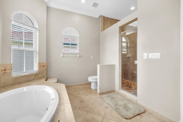 bathroom with shower with separate bathtub, toilet, plenty of natural light, and tile patterned floors