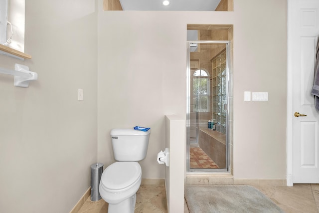 bathroom with an enclosed shower, toilet, and tile patterned floors