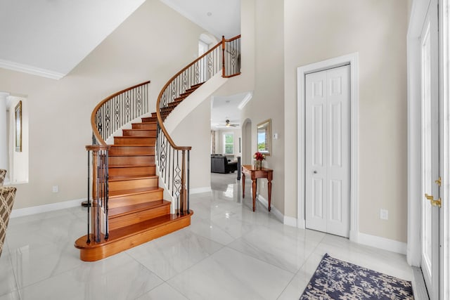 9229 Delemar Ct, Wellington, FL 33414 - foyer entrance featuring a high ceiling, baseboards, stairs, crown molding, and a ceiling fan
