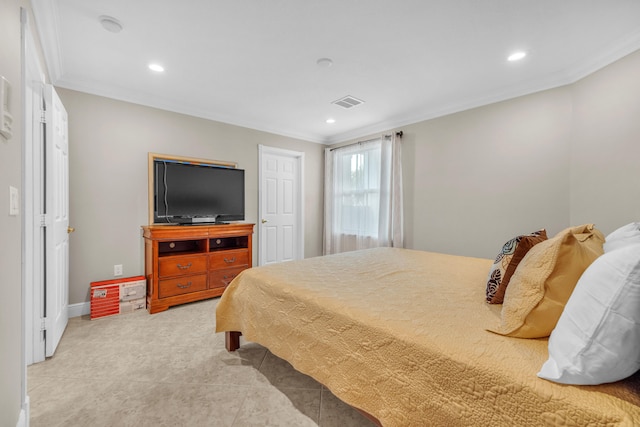 bedroom with ornamental molding and light tile patterned floors