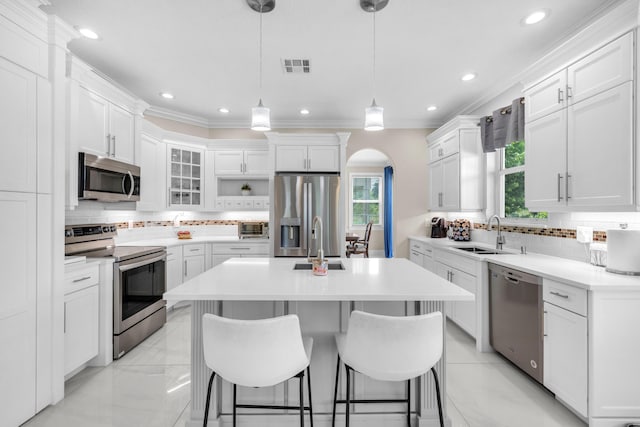 kitchen featuring sink, stainless steel appliances, light tile patterned floors, and backsplash