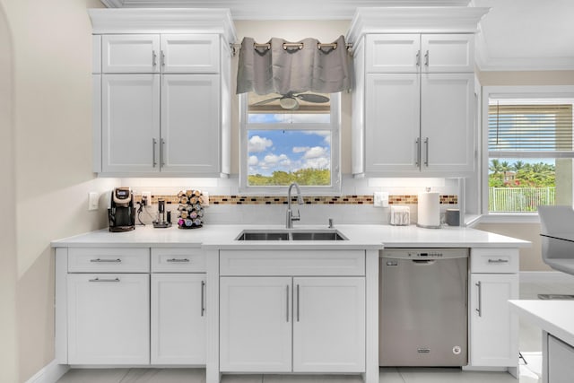 9229 Delemar Ct, Wellington, FL 33414 - kitchen with dishwasher, a sink, white cabinets, crown molding, and light countertops
