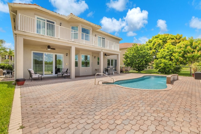 view of swimming pool featuring ceiling fan, a patio, and a grill