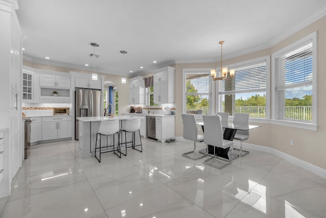 9229 Delemar Ct, Wellington, FL 33414 - dining room featuring a chandelier, ornamental molding, baseboards, and recessed lighting