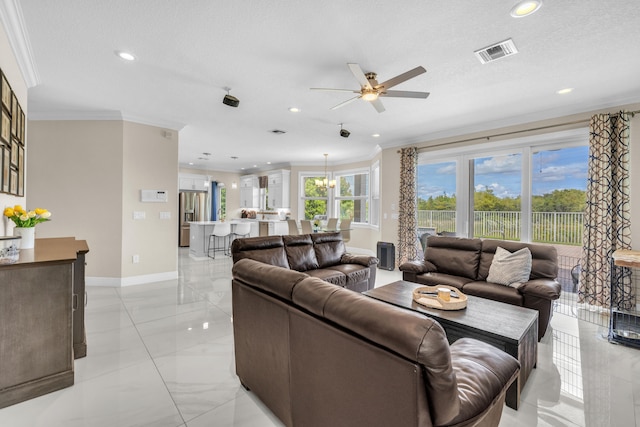 living room featuring light tile patterned floors, ornamental molding, ceiling fan, and a textured ceiling