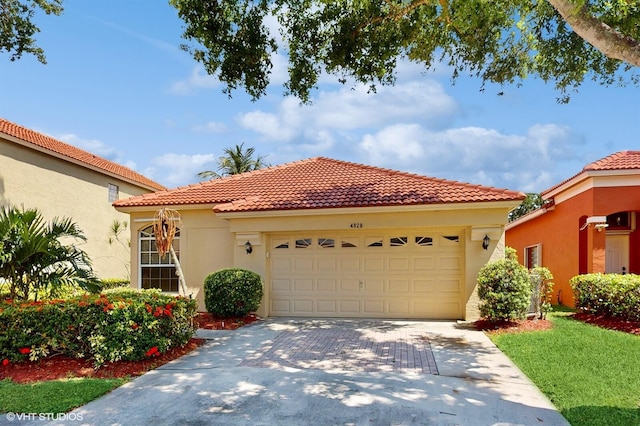 mediterranean / spanish house featuring an attached garage, driveway, a tile roof, and stucco siding