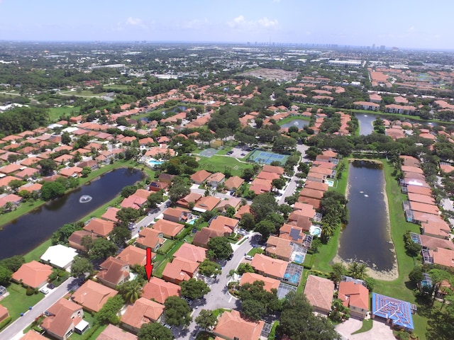 drone / aerial view featuring a water view and a residential view