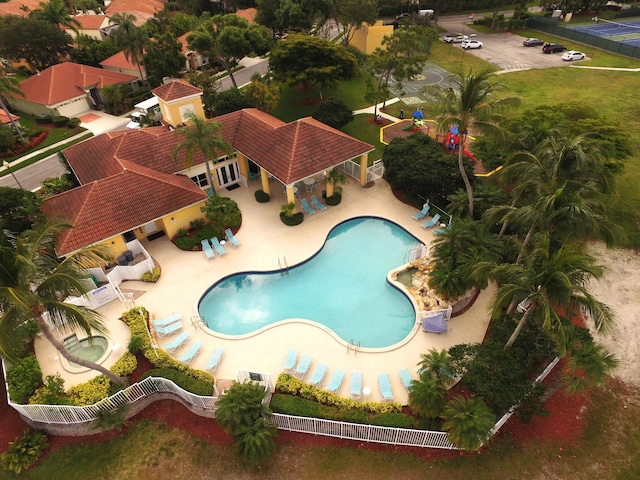 community pool featuring a patio area and fence