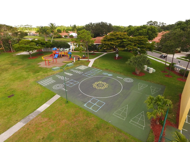 view of sport court with a lawn and playground community