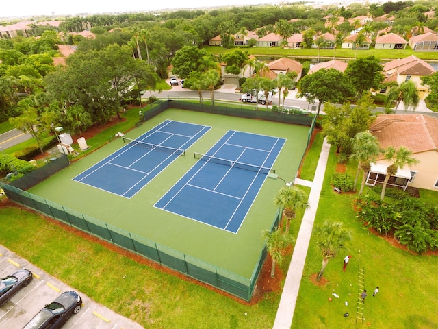 view of sport court with a residential view and fence