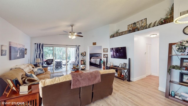 living room featuring high vaulted ceiling, baseboards, ceiling fan, and light wood finished floors