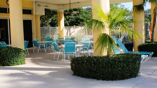 view of patio / terrace featuring outdoor dining area, fence, and a ceiling fan