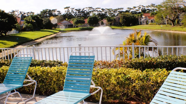 property view of water featuring fence