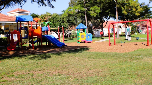 community jungle gym with a yard