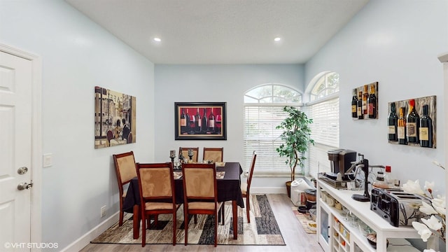 dining room featuring recessed lighting, baseboards, and light wood finished floors