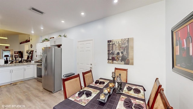 dining room with light wood-style floors, recessed lighting, and visible vents