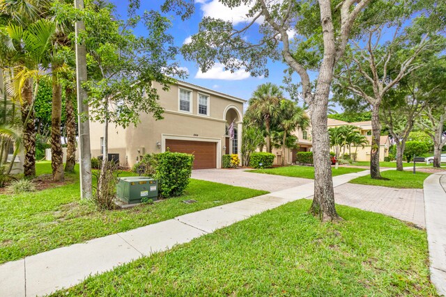 view of front of house featuring a front yard and a garage