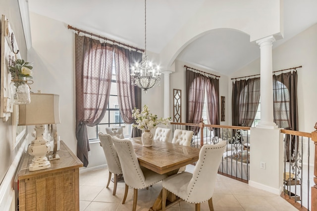 tiled dining space with a notable chandelier, lofted ceiling, and ornate columns