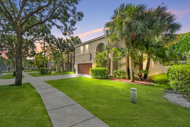 exterior space with a garage and a lawn