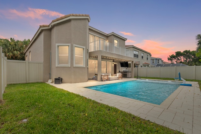 view of swimming pool with ceiling fan, a yard, a patio, and a pergola