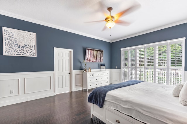 bedroom with ceiling fan, dark hardwood / wood-style flooring, and crown molding