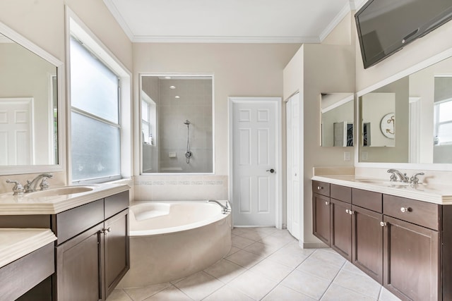 bathroom with dual vanity, a bathtub, ornamental molding, and tile patterned flooring