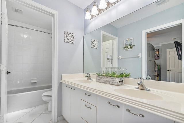 full bathroom featuring tiled shower / bath, toilet, double vanity, and tile patterned flooring