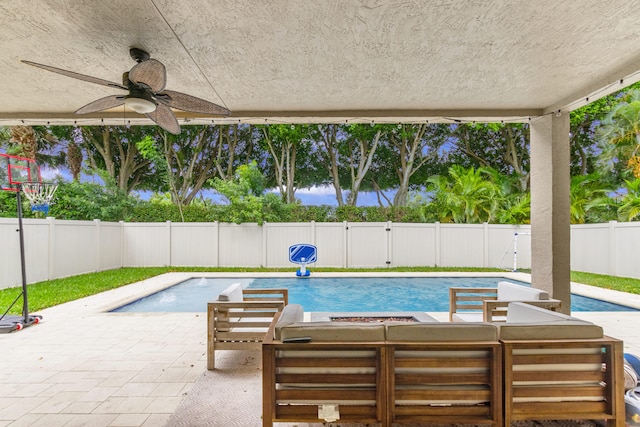 view of swimming pool featuring ceiling fan and a patio