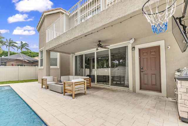 exterior space featuring ceiling fan, an outdoor hangout area, and a fenced in pool