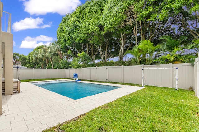 view of pool featuring a patio and a lawn