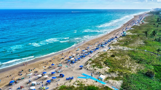drone / aerial view with a beach view and a water view