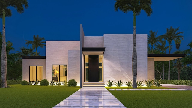 contemporary home featuring a front lawn