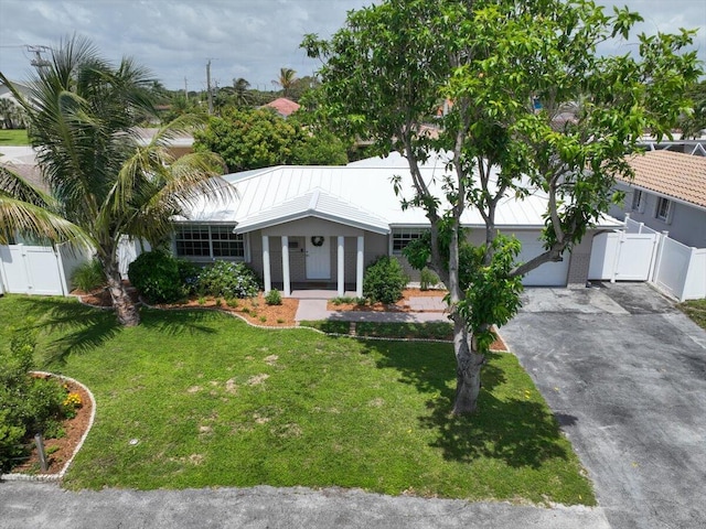 ranch-style house featuring a garage and a front lawn