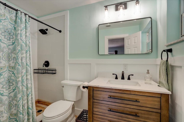 bathroom with vanity, curtained shower, and toilet