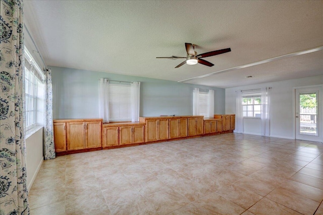 spare room with ceiling fan and a textured ceiling