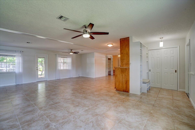 unfurnished room featuring a textured ceiling