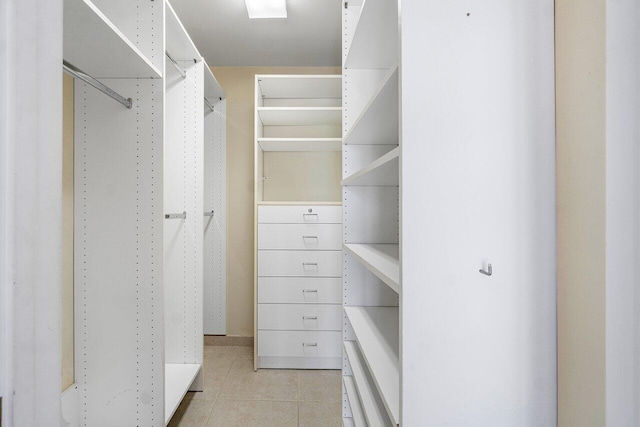 tiled bedroom featuring ceiling fan and two closets